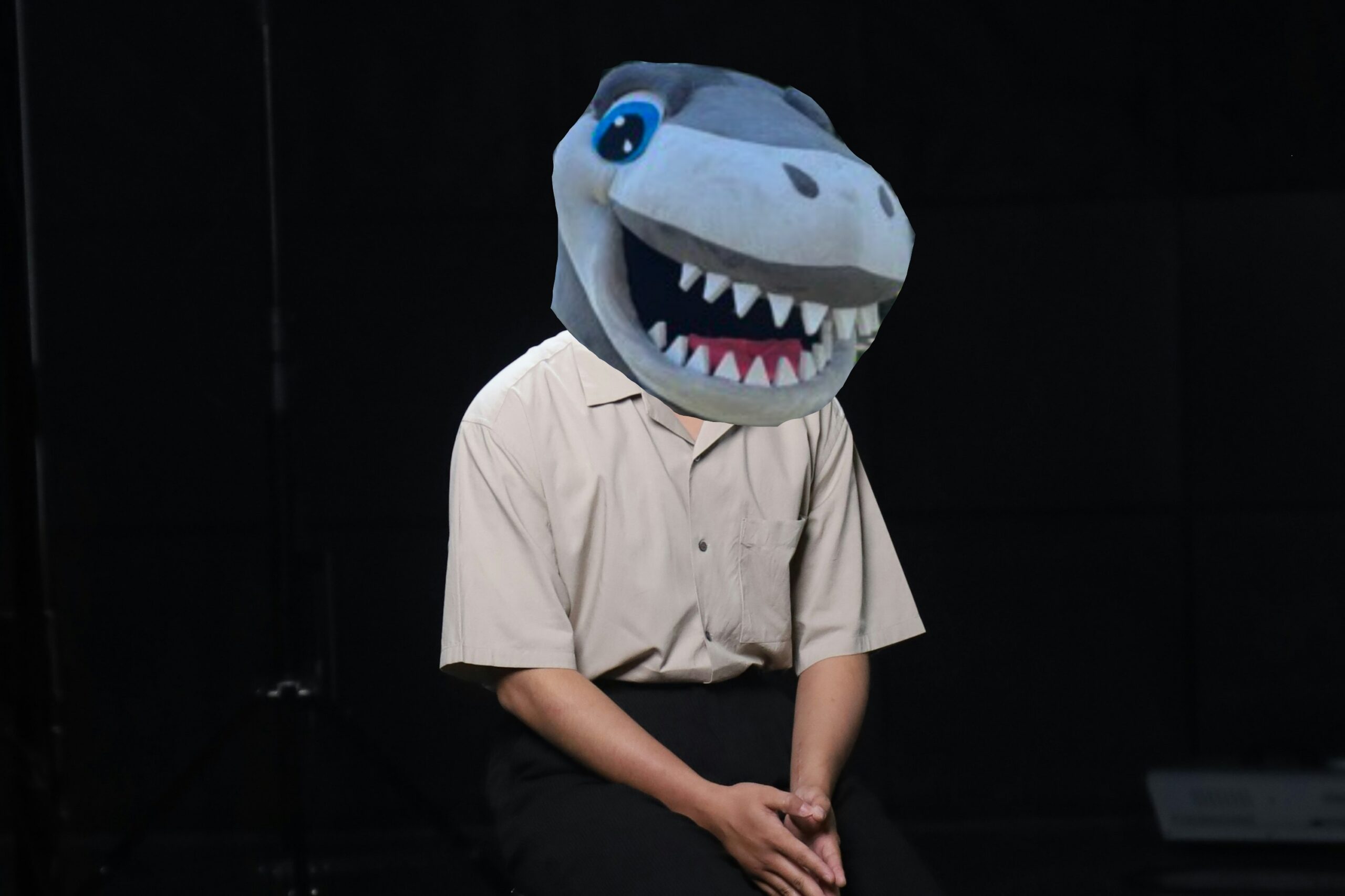 Dalhousie Mascot Shane's head poorly edited over a stock photo of man sitting down in a interview studio