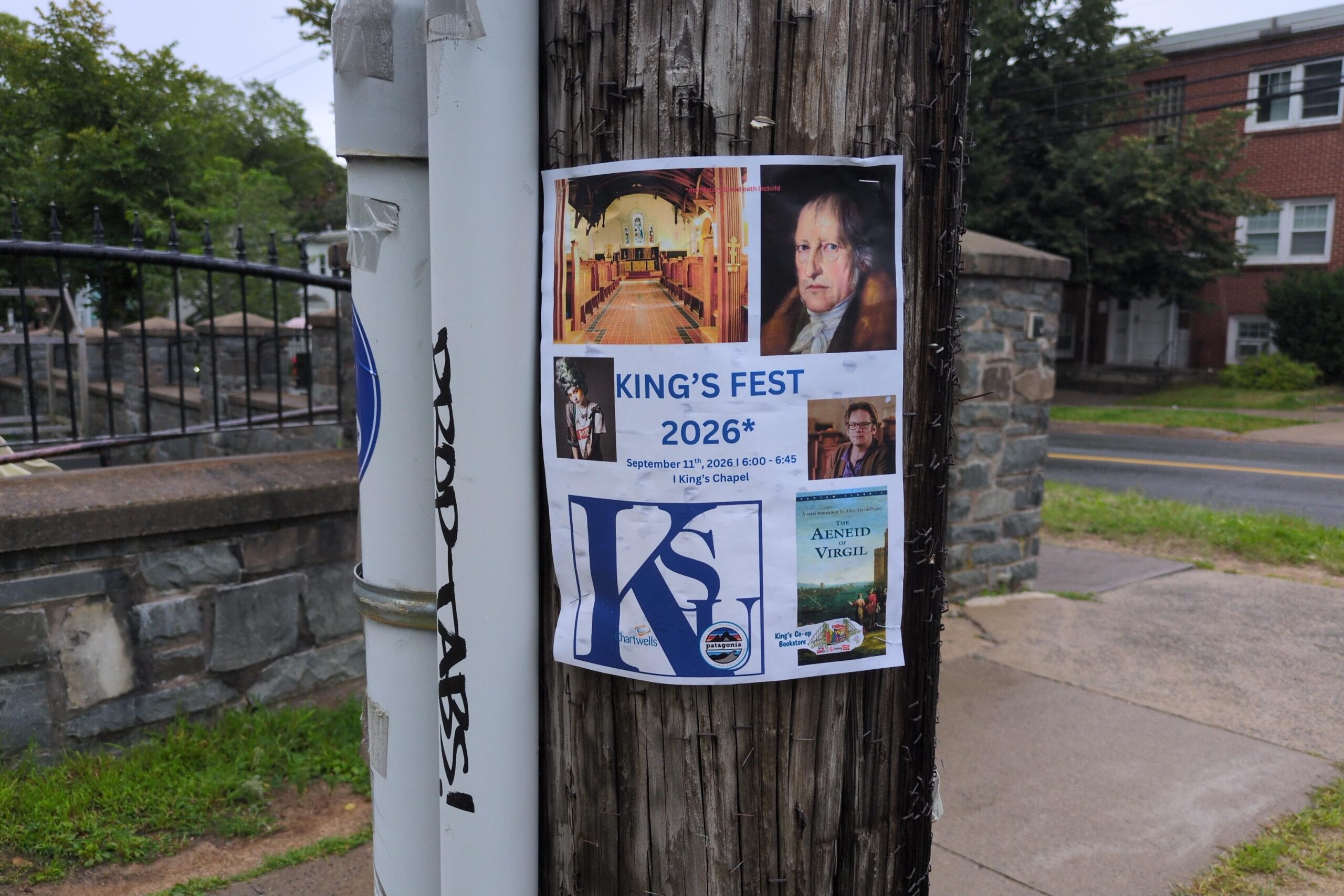 Photo of a King'sFest poster stapled to a telephone pole