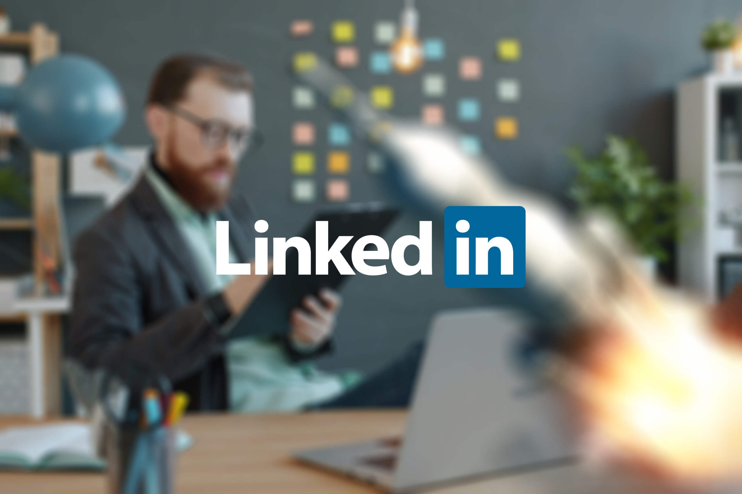 LinkedIn logo overlayed a man using a laptop and a rocketship